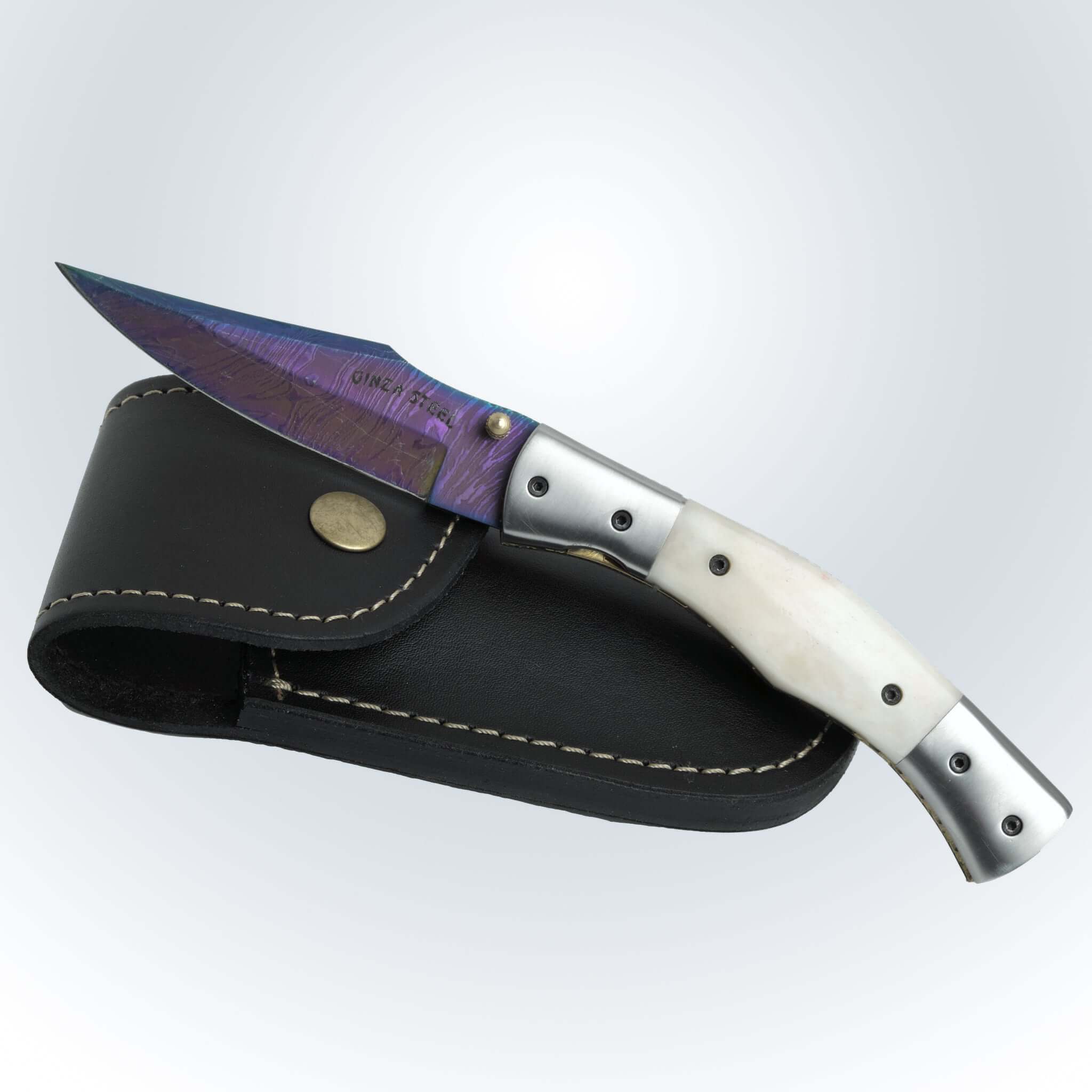 Everyday carry folding knives with a metallic handle and colorful blade, displayed with a leather sheath.