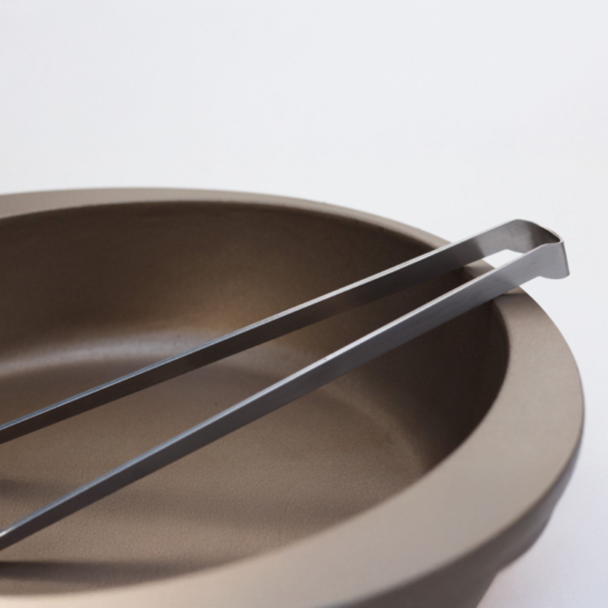 Eatoco Japan Stainless Steel Saibashi Tongs resting over a modern brown bowl.