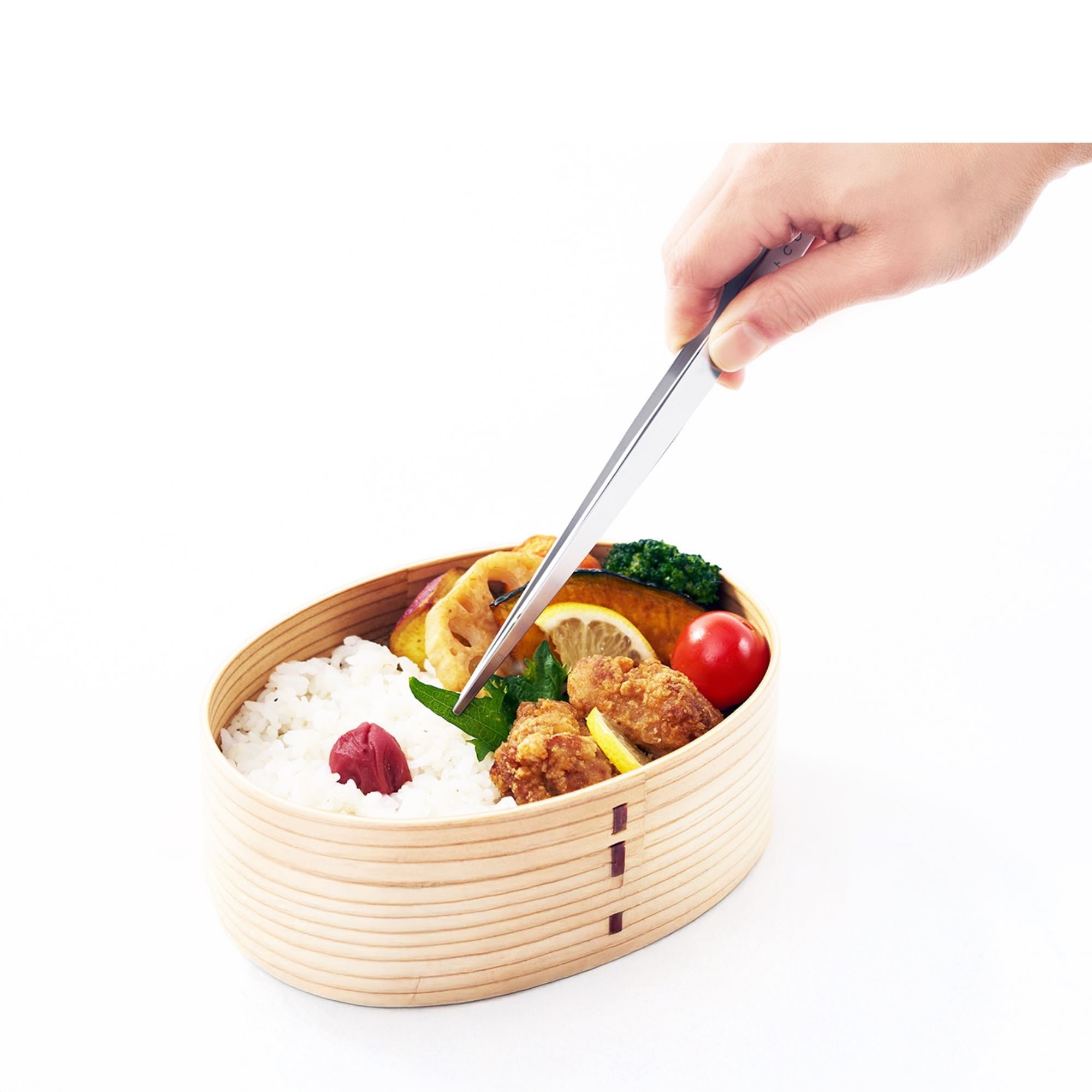Eatoco Japan Stainless Steel Moribashi Bento Tongs picking colorful ingredients from a bento box.