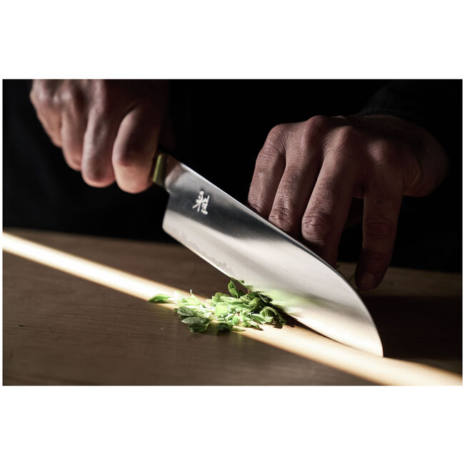  man cutting with MIYABI 4000 FCV2 KOYA Santoku Knife