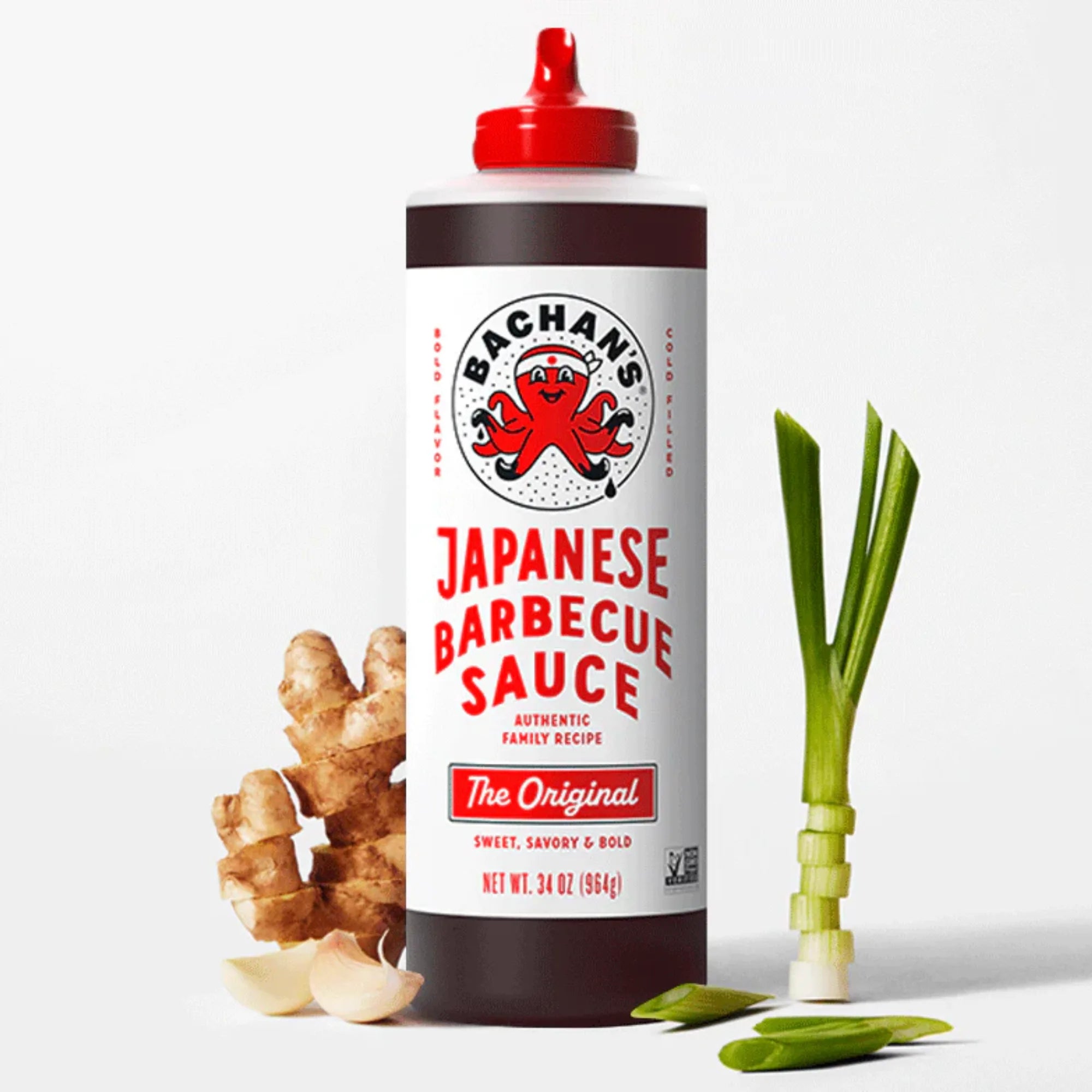 Bachan’s Original Japanese Barbecue Sauce bottle with ginger and scallions on a white background.