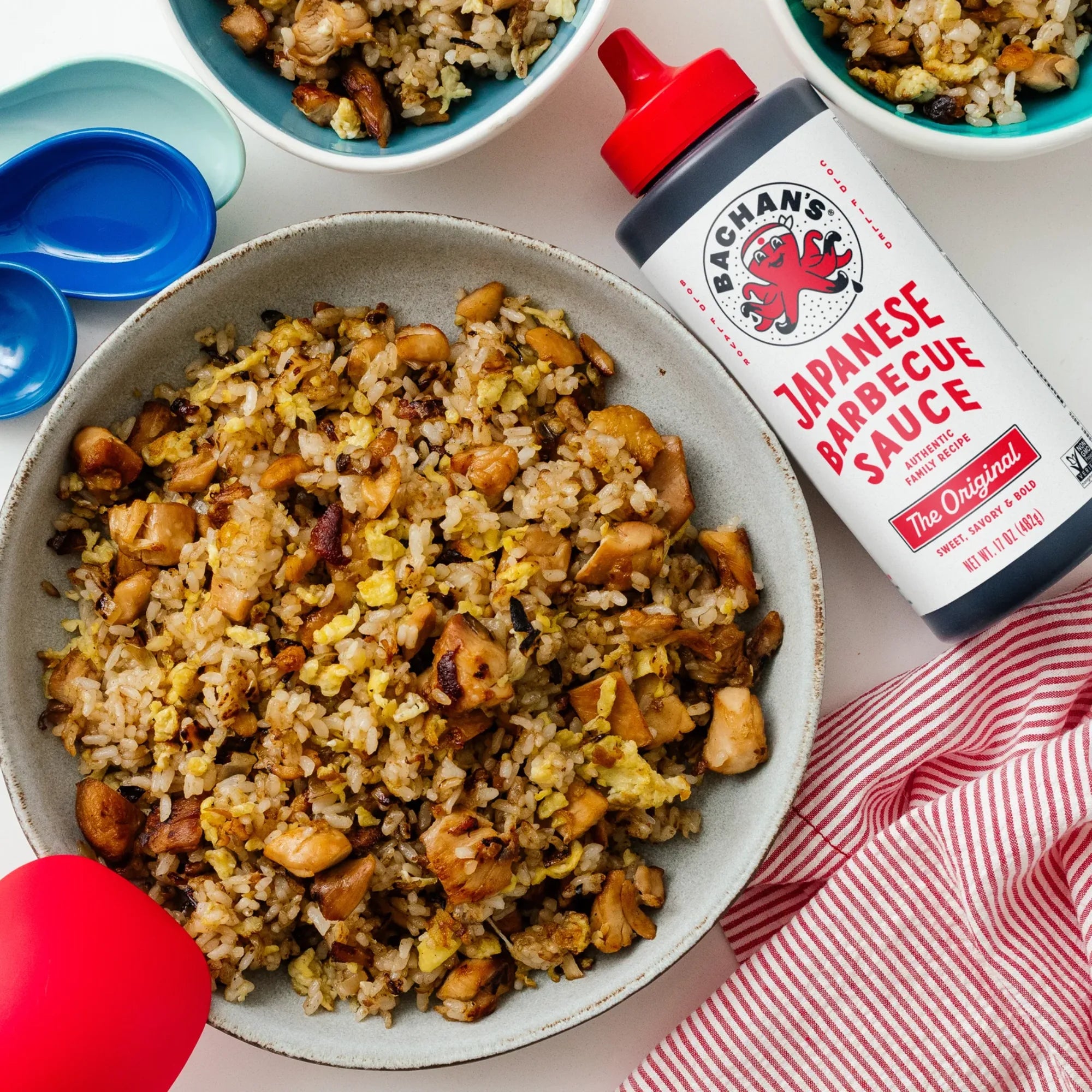 Bachan’s Original Japanese Barbecue Sauce used with fried rice and chicken in a bowl, showcasing rich flavors.