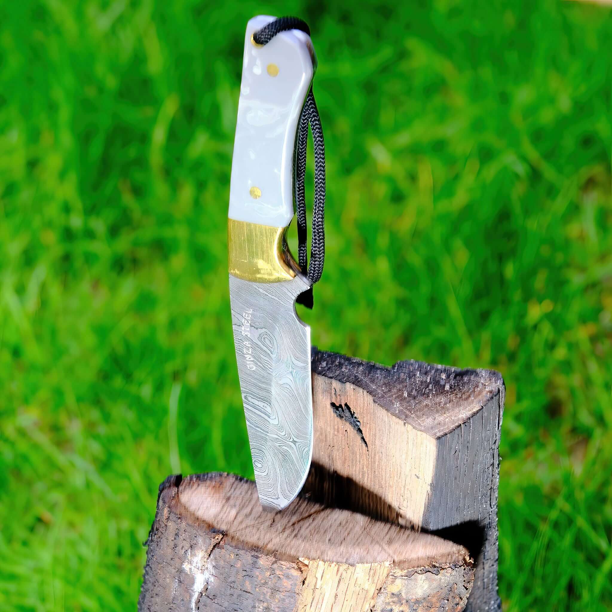 Kaito Damascus Steel Skinner Knife stuck in wood log outdoor