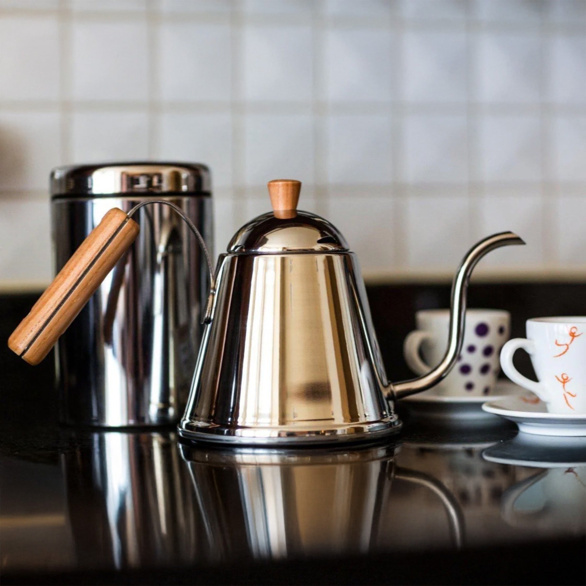 Yoshikawa Café Time Japanese pour-over coffee kettle in stainless steel with wooden handle on a kitchen counter.