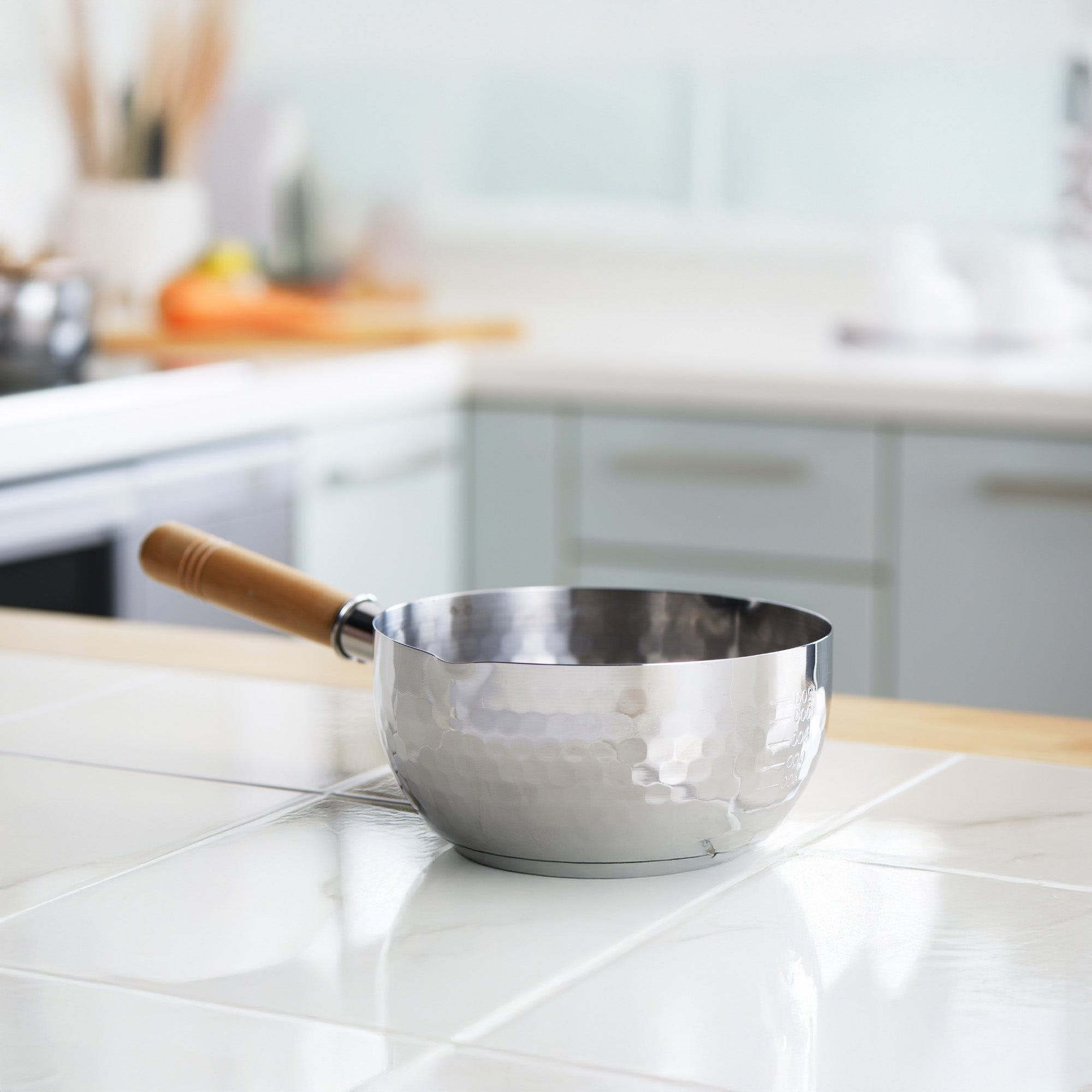 Yoshikawa Yukihira Saucepan 20cm with Lid showcasing its lightweight hammered stainless steel design in a kitchen setting.